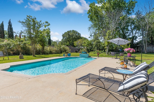 view of swimming pool with a lawn and a patio