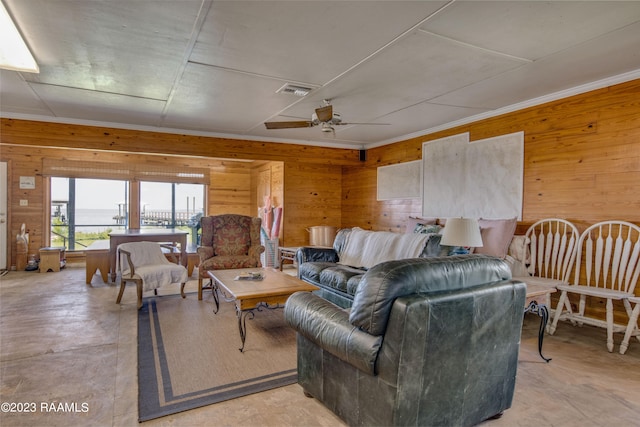 living room with wood walls and ceiling fan