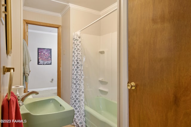 bathroom with shower / bath combination with curtain, ornamental molding, and sink