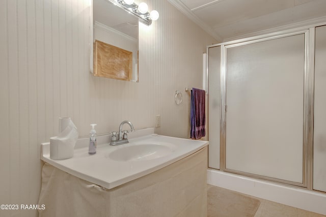 bathroom with a shower with shower door, tile flooring, and vanity