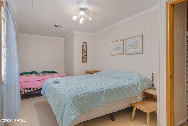 bedroom featuring crown molding and light tile floors