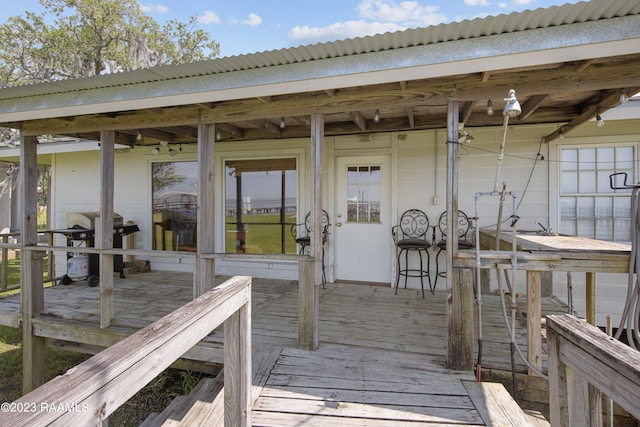 wooden deck with a grill