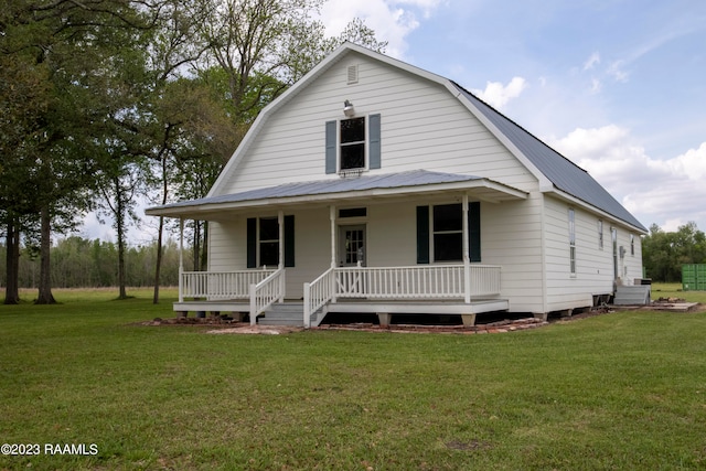 farmhouse-style home with covered porch and a front yard