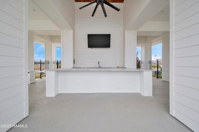 view of patio with exterior bar and ceiling fan