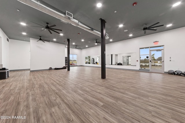 interior space featuring hardwood / wood-style floors and a towering ceiling