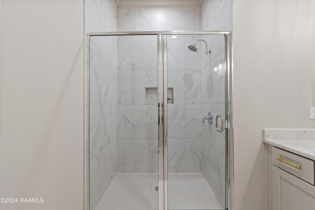 bathroom with vanity and a shower with door