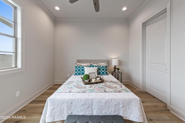 bedroom with ceiling fan, hardwood / wood-style floors, and crown molding