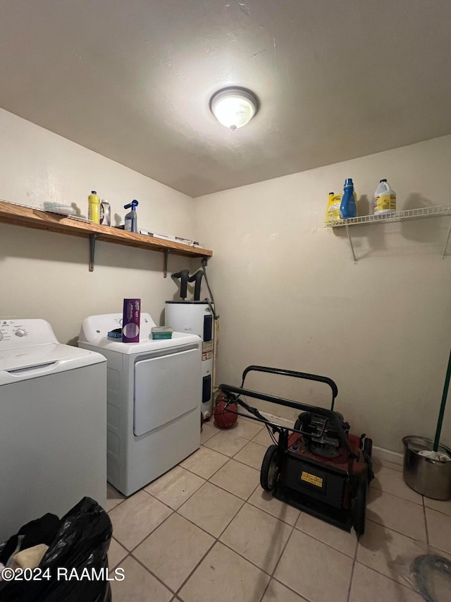 washroom featuring electric water heater, separate washer and dryer, and light tile patterned floors