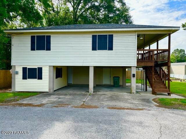 view of front of house with a carport and a deck