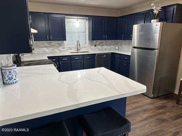 kitchen with kitchen peninsula, stainless steel fridge, sink, dishwasher, and dark hardwood / wood-style floors