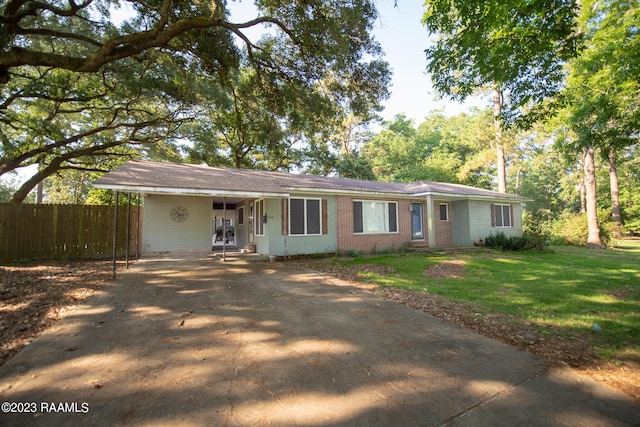 single story home with a front yard and a carport