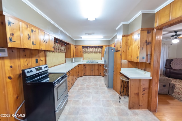 kitchen with ceiling fan, sink, stainless steel appliances, light tile floors, and crown molding