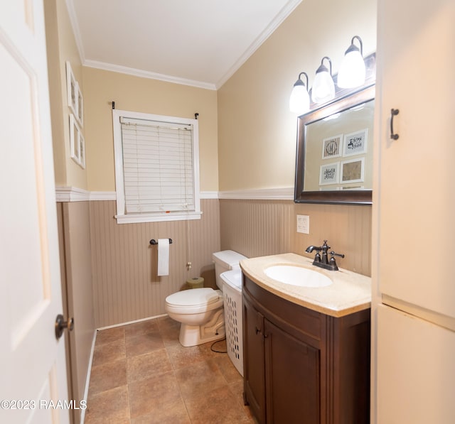 bathroom featuring ornamental molding, toilet, vanity, and tile floors