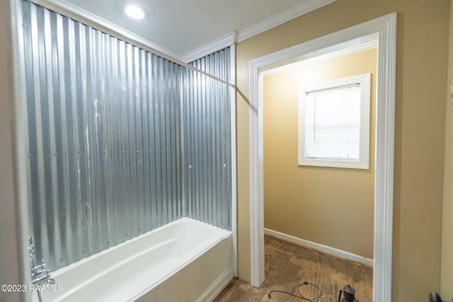 bathroom featuring crown molding, bathtub / shower combination, and hardwood / wood-style flooring