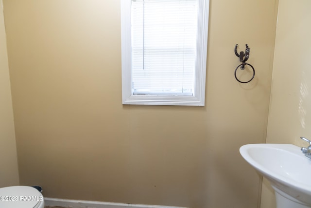 bathroom featuring sink and toilet