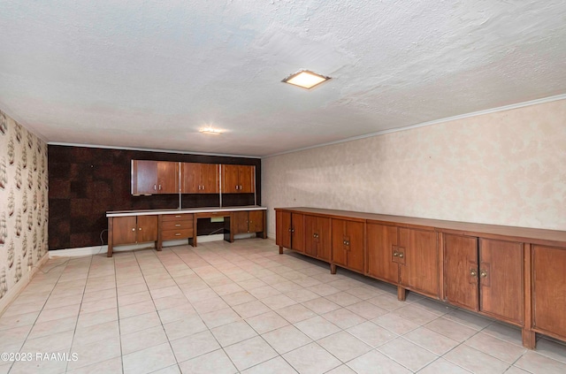 tiled empty room featuring a textured ceiling