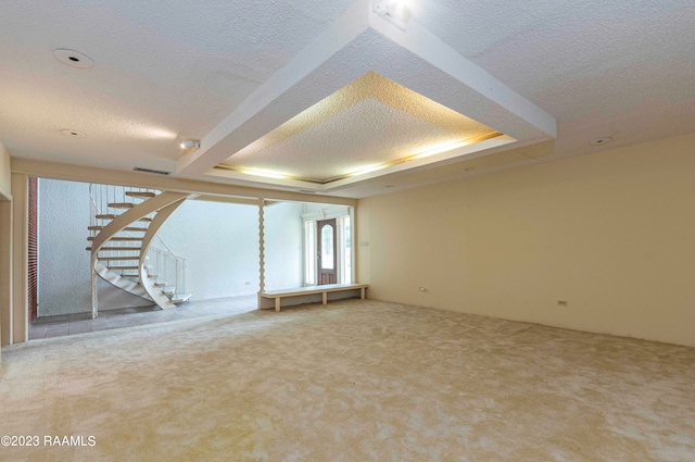 carpeted spare room featuring a textured ceiling