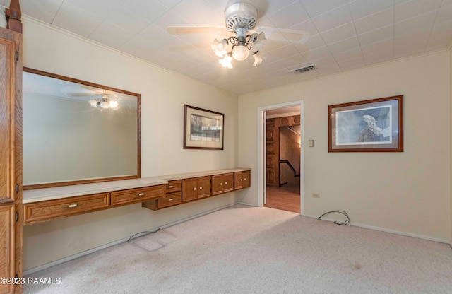 interior space with light colored carpet and ceiling fan