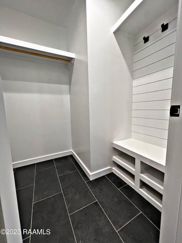 walk in closet featuring dark tile patterned floors