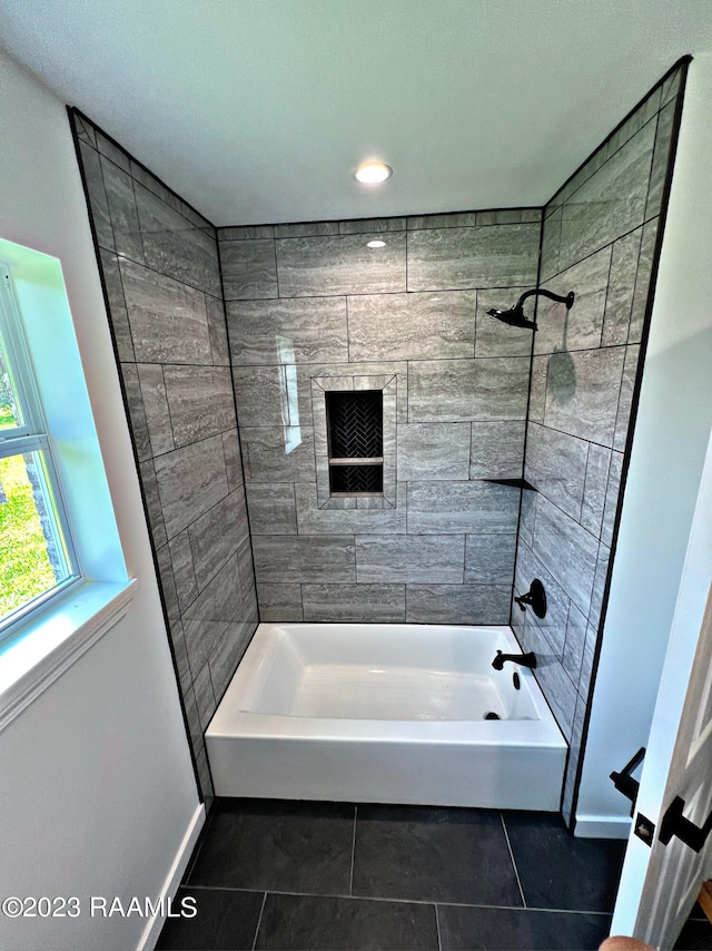 bathroom featuring tile patterned flooring and tiled shower / bath combo