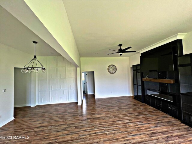 living room featuring wood-type flooring and ceiling fan with notable chandelier