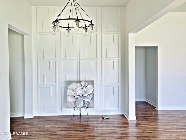 details with hardwood / wood-style floors and a notable chandelier