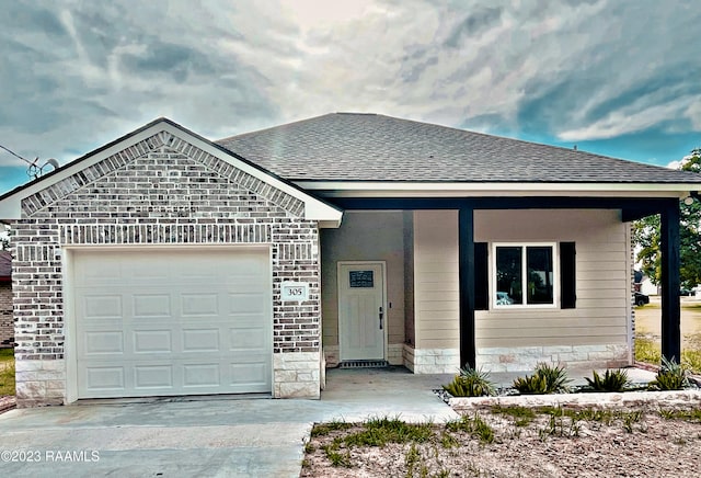 view of front of house featuring a porch and a garage