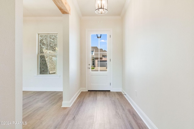 doorway with crown molding, baseboards, and wood finished floors