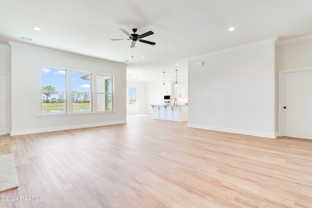 unfurnished living room featuring recessed lighting, light wood-style flooring, baseboards, and ornamental molding