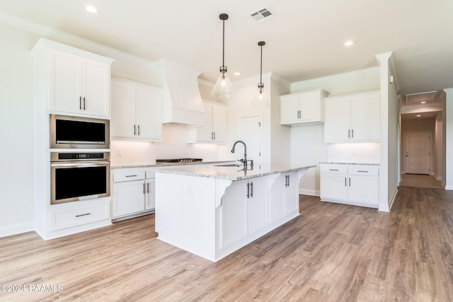 kitchen with oven, a sink, light wood-style floors, white cabinets, and custom exhaust hood