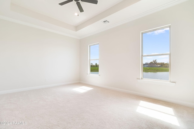 unfurnished room featuring a tray ceiling, visible vents, and baseboards