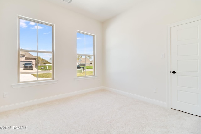 empty room featuring carpet flooring and baseboards