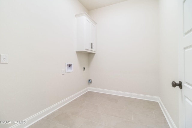 clothes washing area featuring cabinet space, hookup for an electric dryer, baseboards, and washer hookup