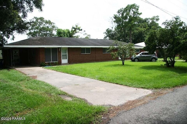 single story home featuring a front lawn and a carport