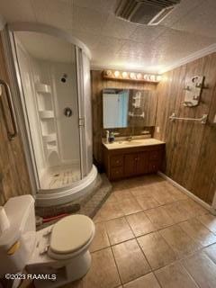 bathroom featuring toilet, wood walls, vanity, crown molding, and tile floors