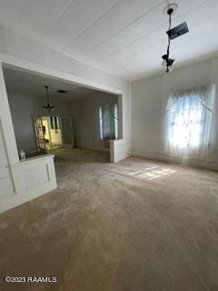 unfurnished living room with light colored carpet