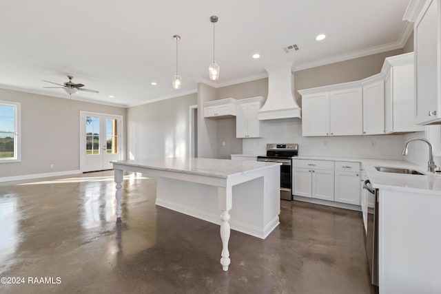 kitchen with custom exhaust hood, white cabinets, sink, stainless steel electric range oven, and a kitchen island