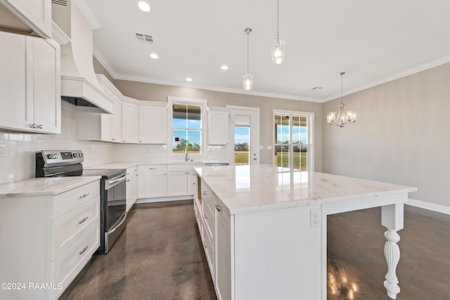 kitchen featuring pendant lighting, a center island, electric range, a notable chandelier, and white cabinetry