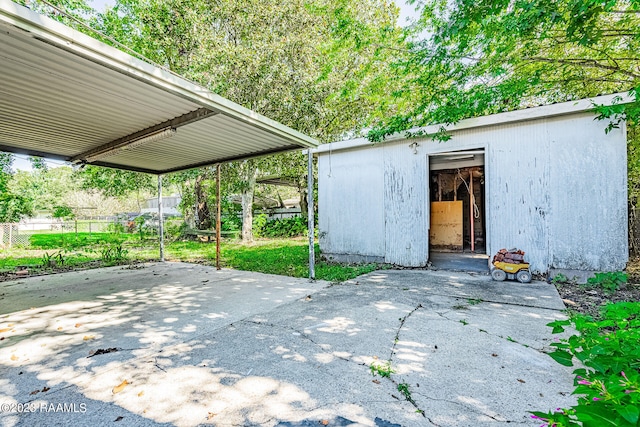 view of terrace featuring a carport and a shed