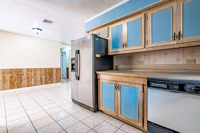 kitchen featuring light tile floors, stainless steel fridge, and dishwasher