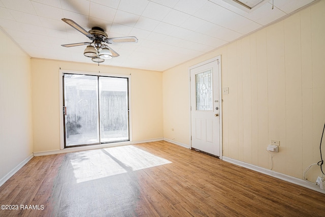 empty room featuring ceiling fan and light hardwood / wood-style flooring