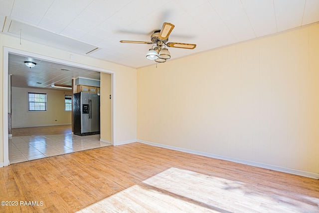 spare room with ceiling fan and light wood-type flooring