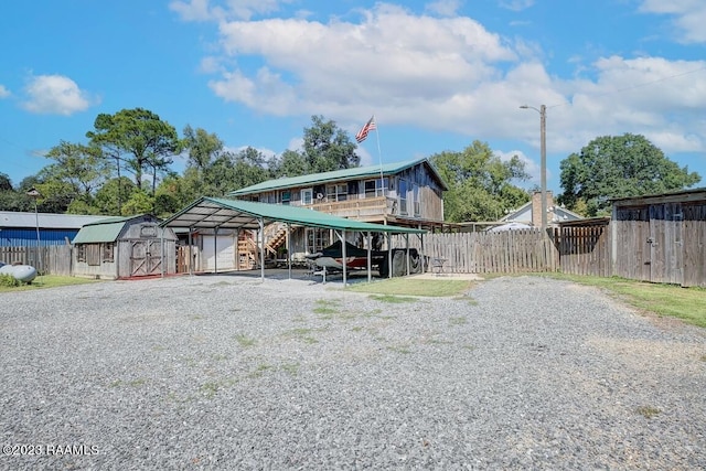 exterior space with a carport and a storage shed