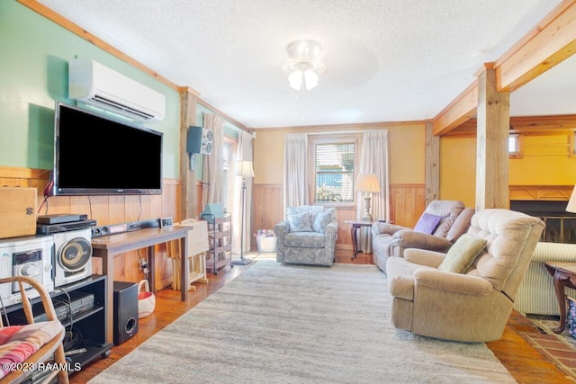 living room with hardwood / wood-style floors, a textured ceiling, and an AC wall unit