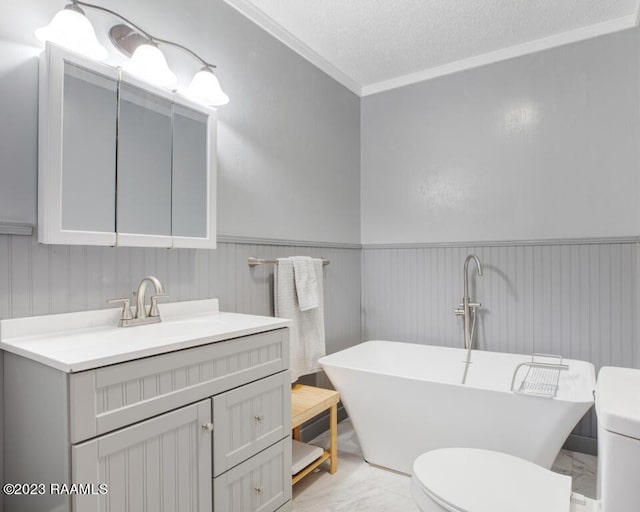 bathroom featuring a washtub, crown molding, vanity, a textured ceiling, and toilet