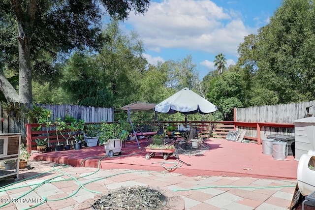 view of patio / terrace featuring a deck and an outdoor fire pit