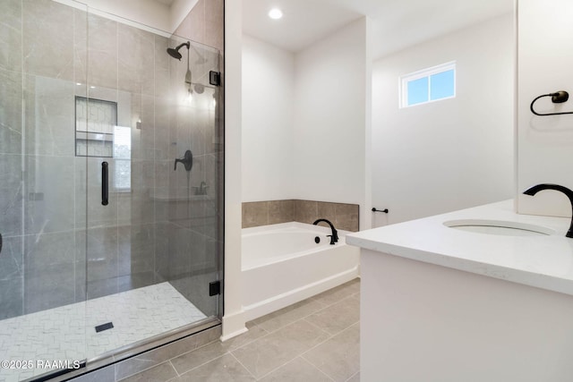 bathroom with tile patterned floors, vanity, and separate shower and tub