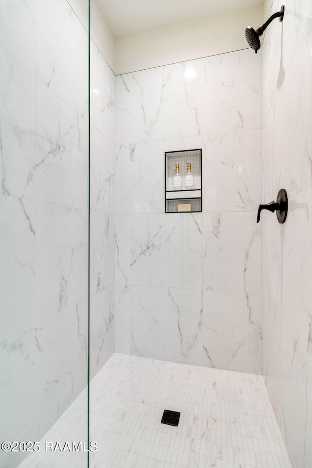 bathroom with a tile shower