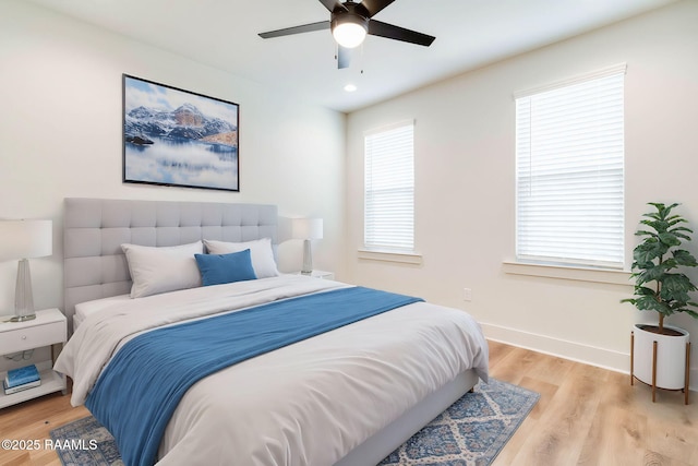 bedroom with ceiling fan and light hardwood / wood-style flooring