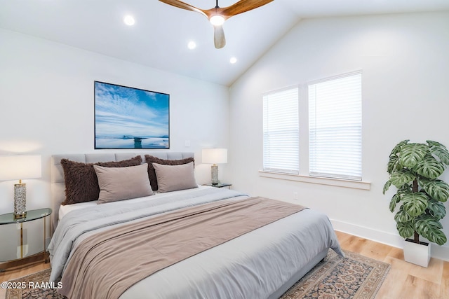 bedroom featuring ceiling fan, light wood-type flooring, and vaulted ceiling